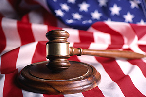 Photo of a gavel on an American flag.